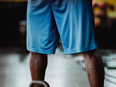 Person hands holding a kettlebell during training session.